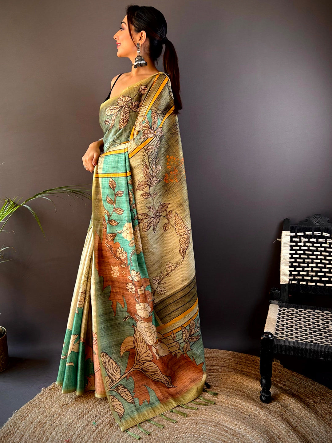 Side view of green abstract floral zari tussar saree.