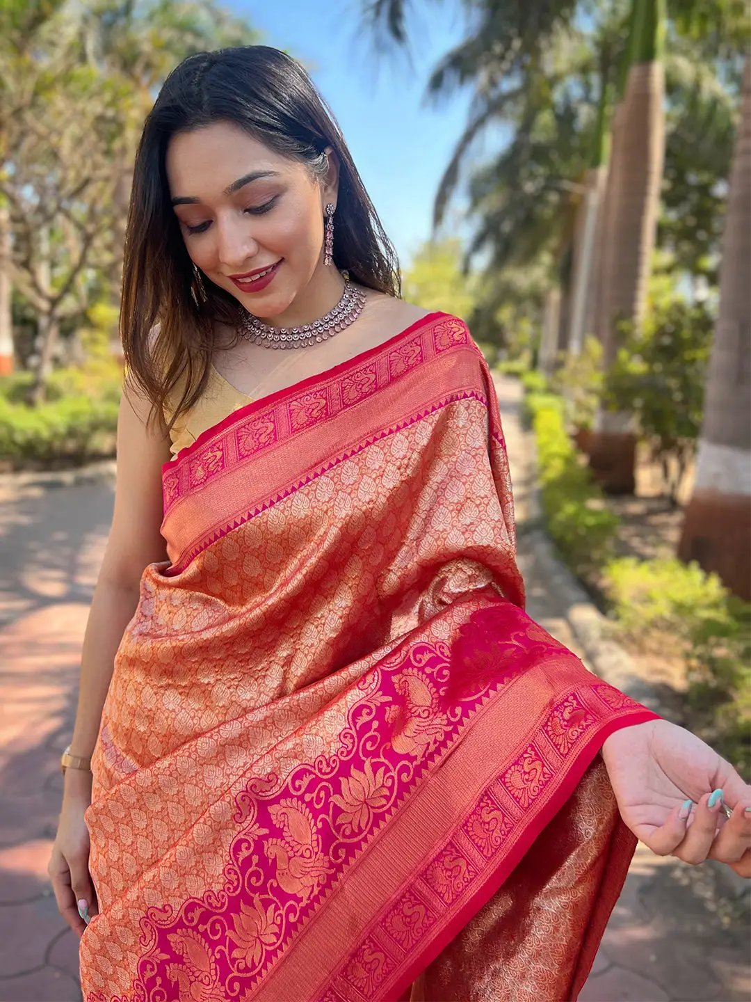 Close-up of gold tissue Kanjivaram saree with pink border