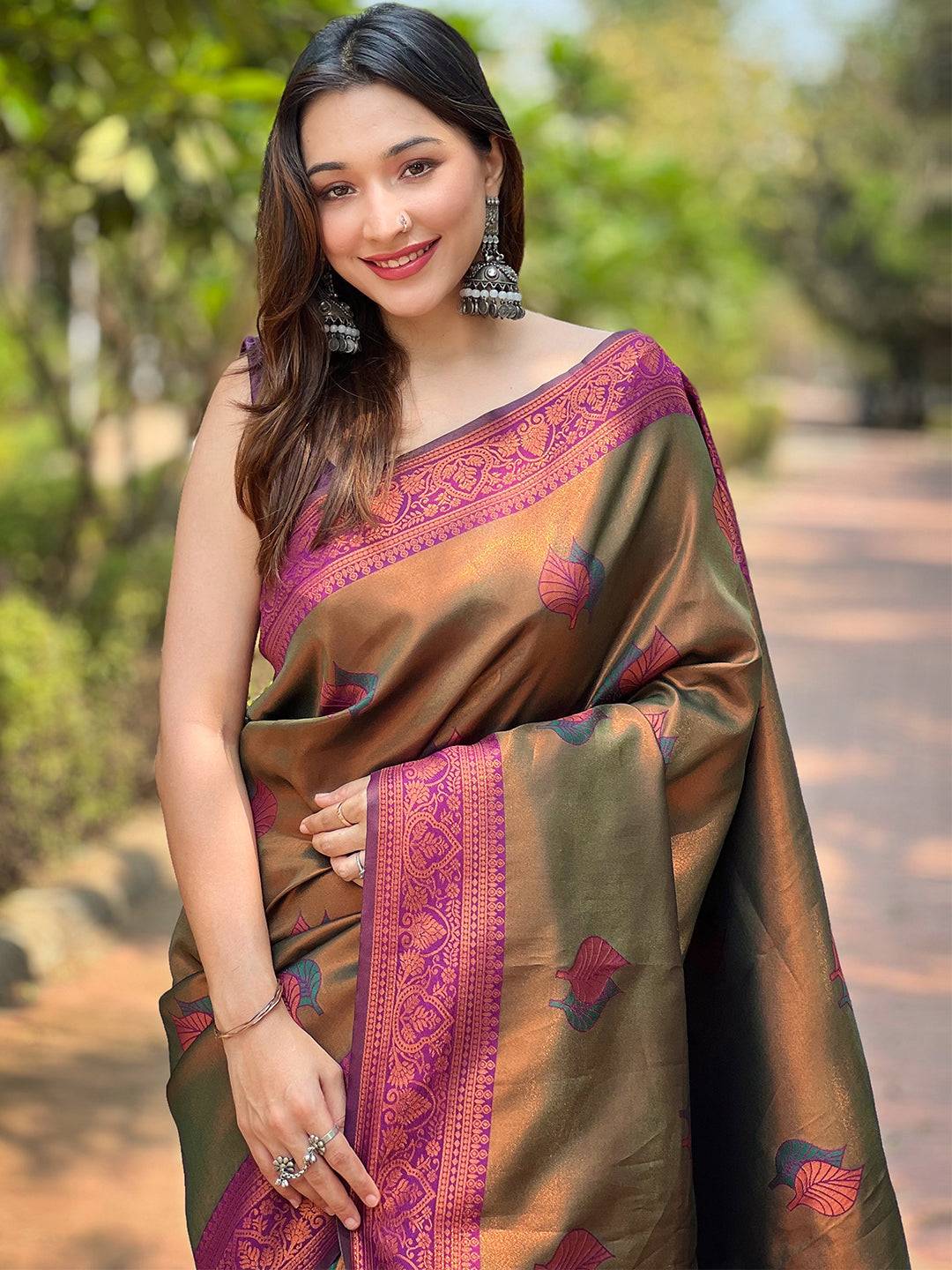 Woman wearing Midium Bronze Kanjivaram Tissue Saree with Gold Zari.