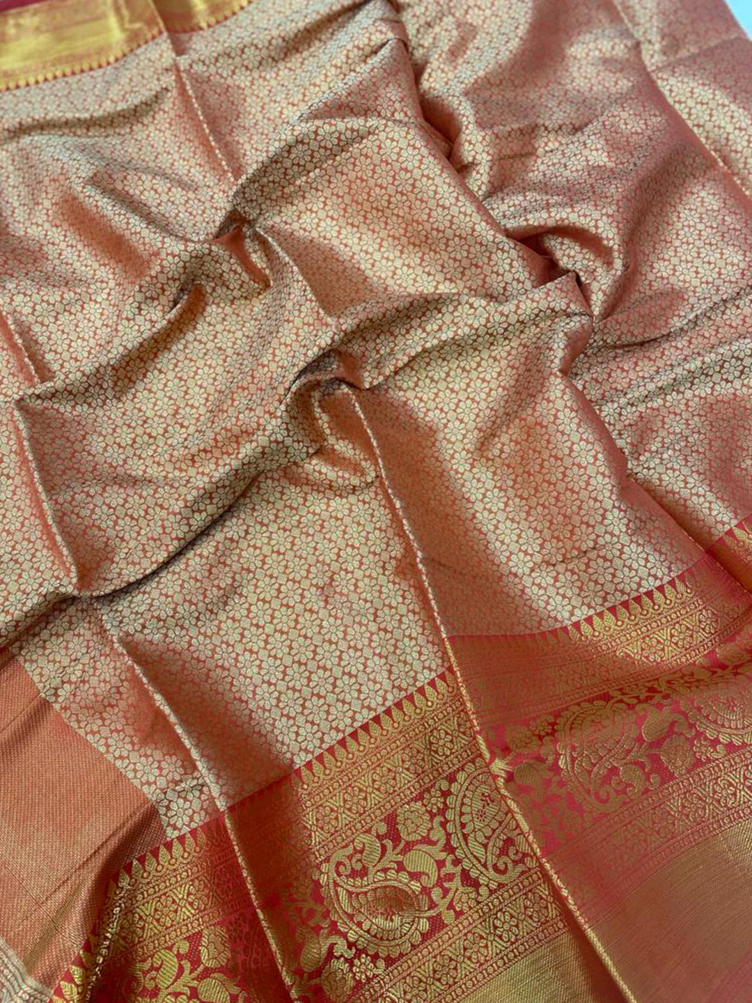 Close-up of intricate gold zari work on Kanjivaaram silk saree.