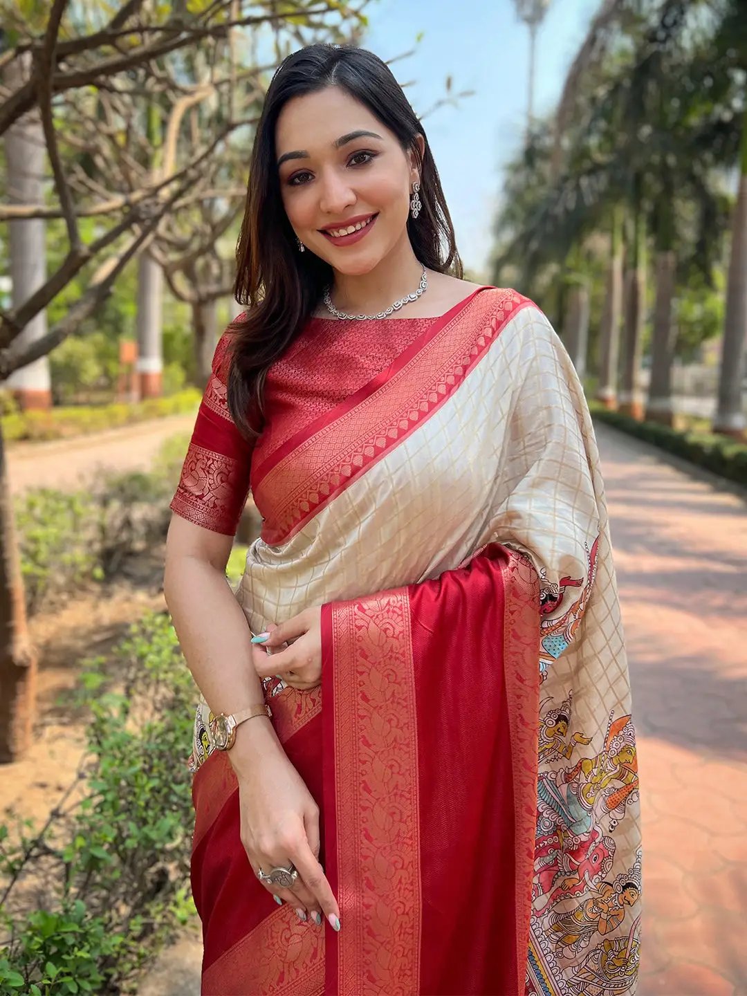 Close-up of cream Banarasi saree with red border and chex pattern