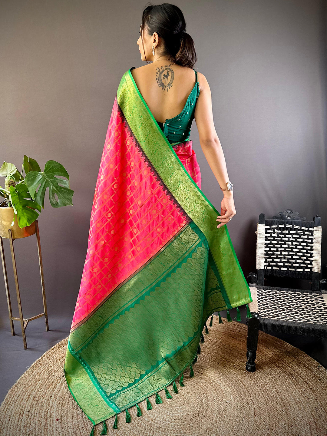 Back view of blush pink Banarasi saree with detailed green border