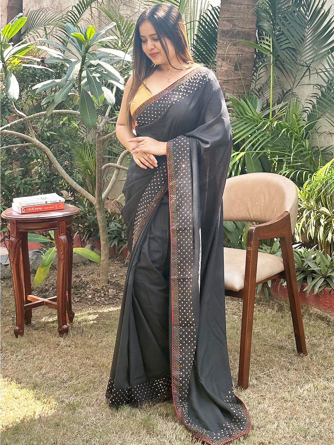 Black Vichitra Silk Saree with Swarovski Stones, outdoor setting