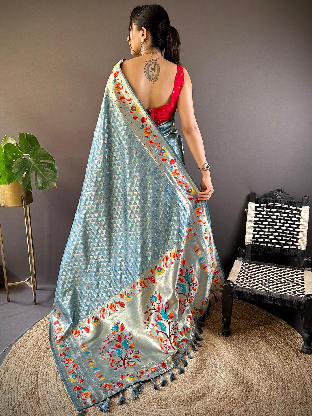 Back view of light blue Paithani saree with intricate zari work.