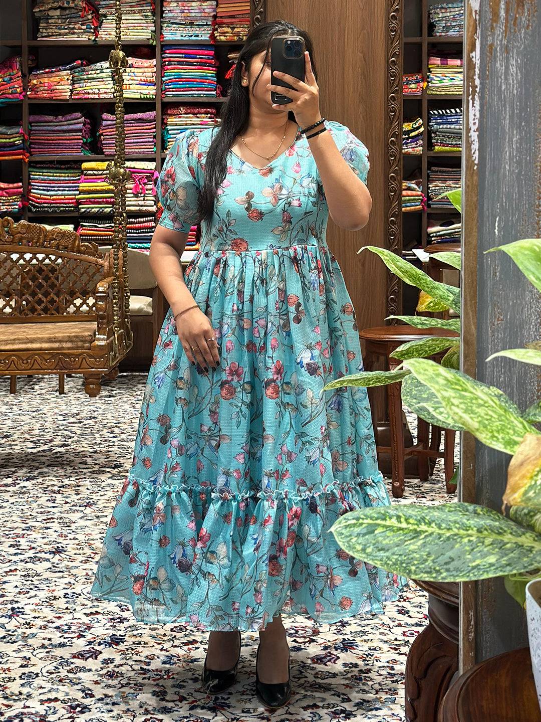 Floral print dress in powder blue with short puff sleeves and V-neck.