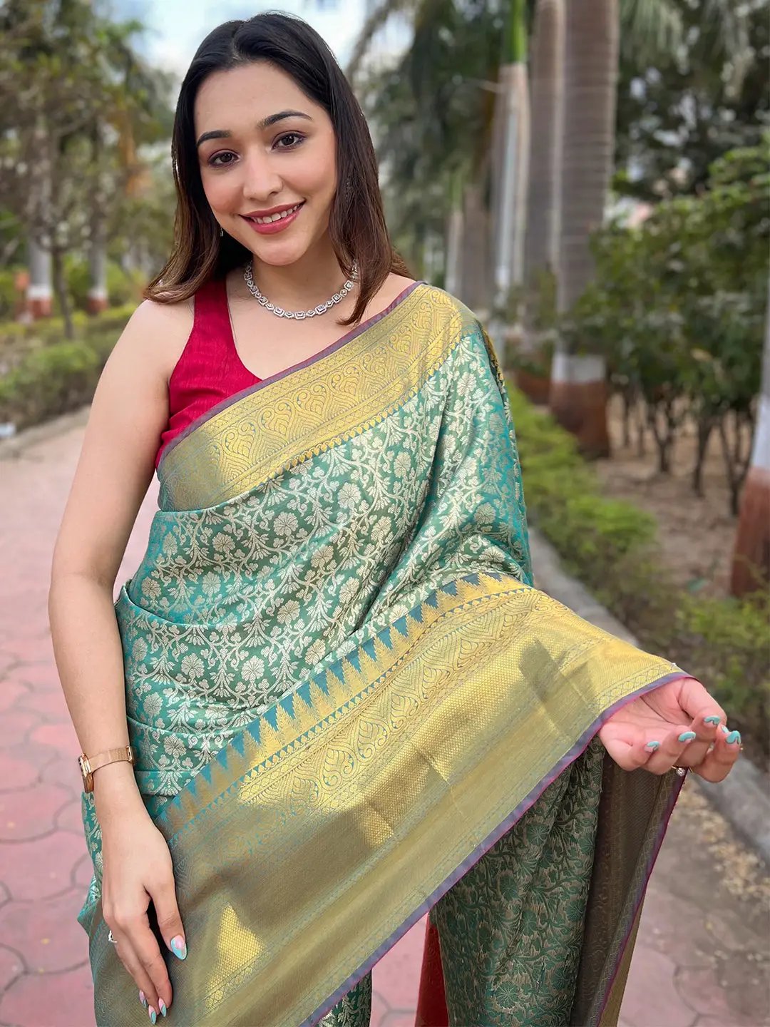 Model wearing Rama Colour Gold Tissue Saree with intricate design