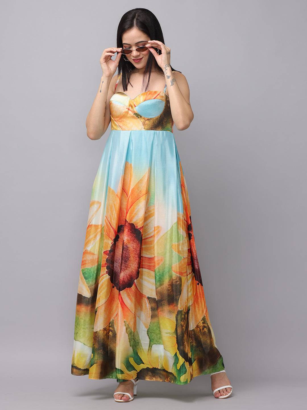 Model adjusting sunglasses in floral print long dress