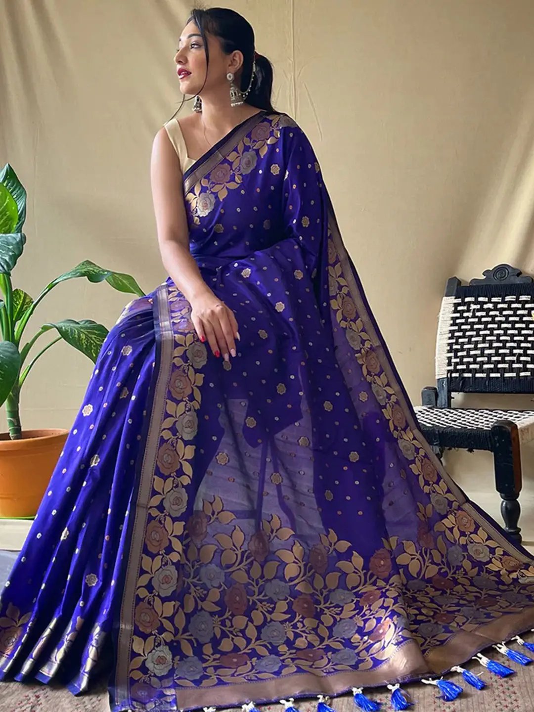 Model wearing royal blue Banarasi silk saree with gold zari