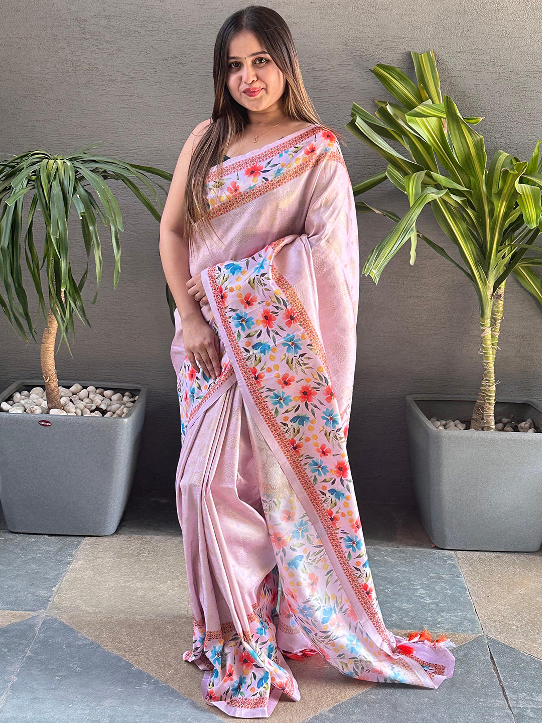 Light pink Kanjivaram saree with floral print, standing view