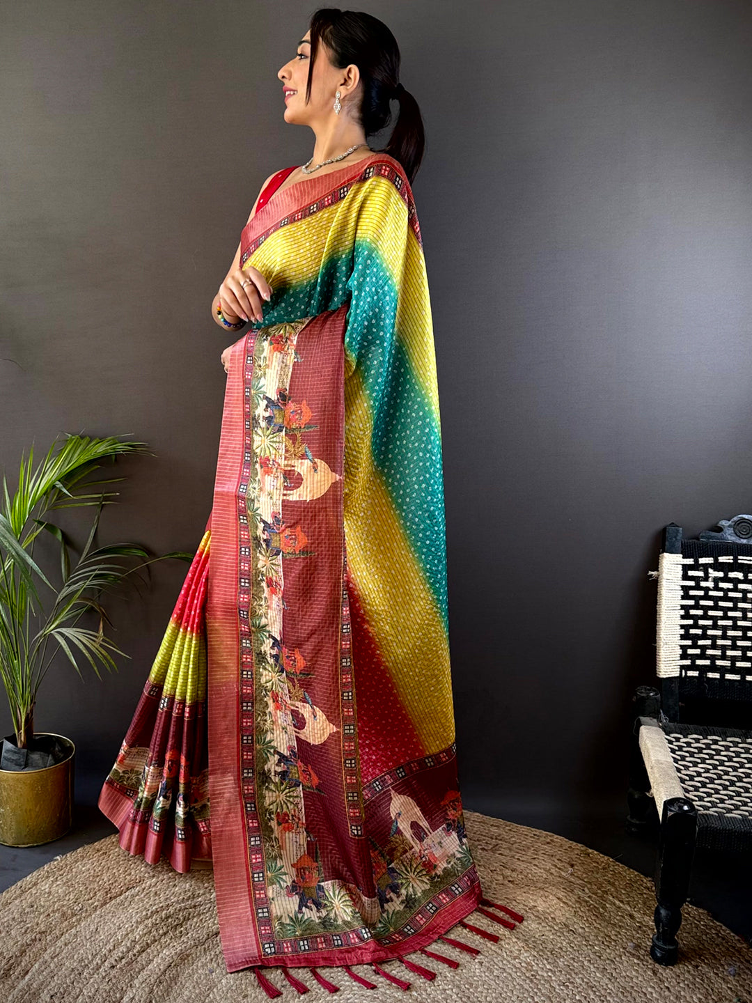 Side pose of a model wearing the Elegant Silk Blend Bandhani Print Saree, highlighting its soft silk texture and exquisite traditional motifs.