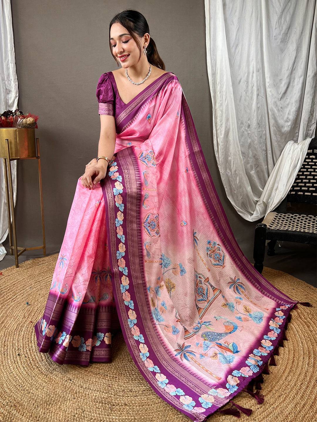 Elegant pink Kota saree with satin border, showcasing floral patterns.