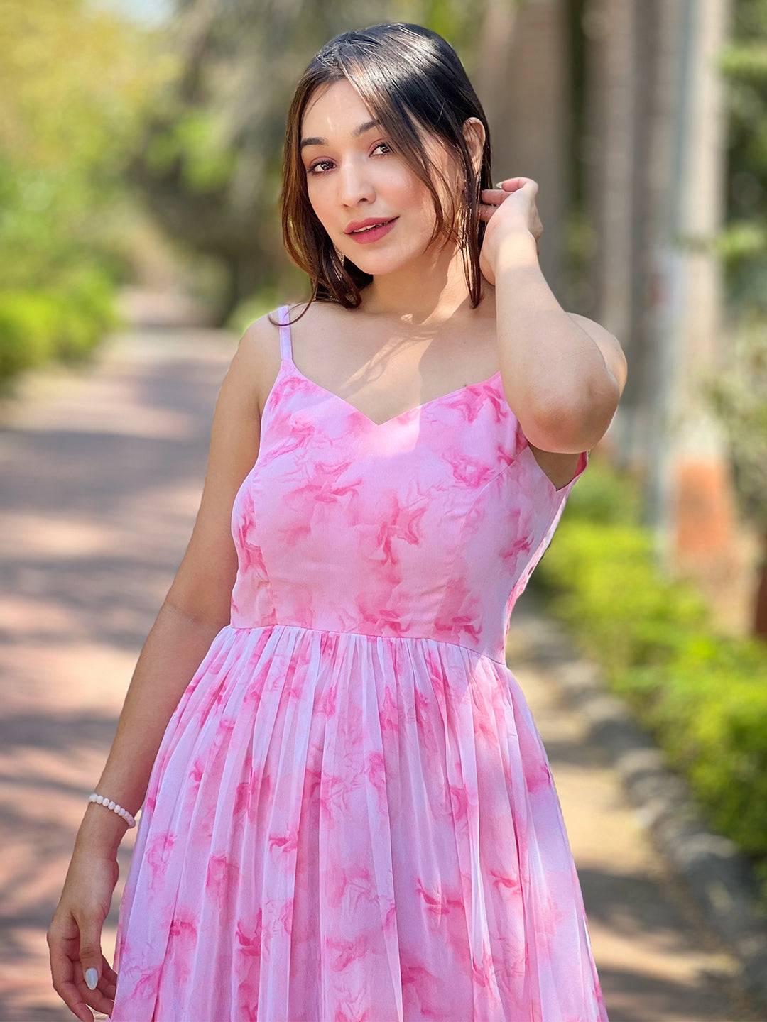 Close-up of woman in blush pink batik dress smiling