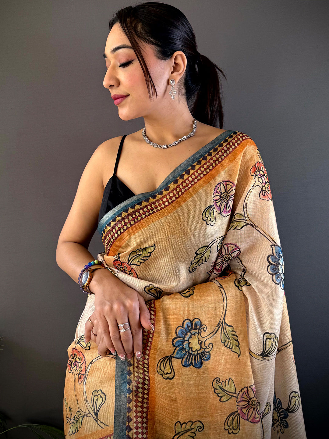 Elegant Radiant Orange Zari Tussar Floral Saree with intricate floral motifs and zari detailing, draped gracefully for a sophisticated ethnic look.