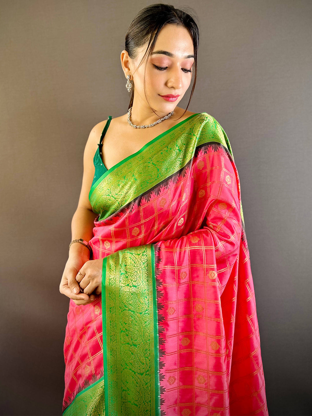 Model wearing blush pink Kovai Banarasi silk saree with green border