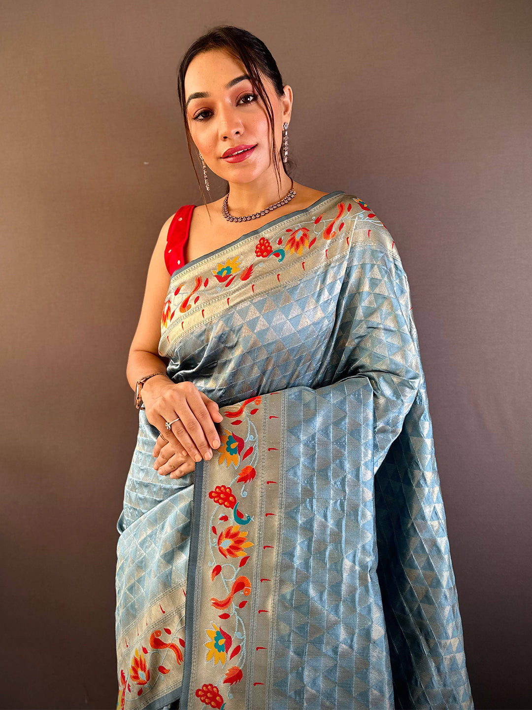 Light blue silk Paithani saree with zari work draped on model.