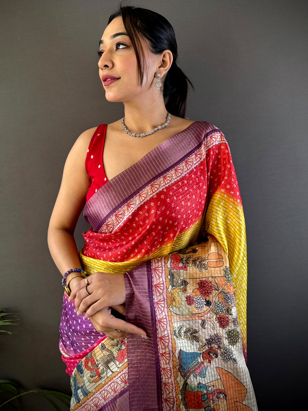 Artful Silk Blend Bandhani Print Saree featuring vibrant hues and intricate patterns, draped elegantly. Perfect for festive and wedding occasions.