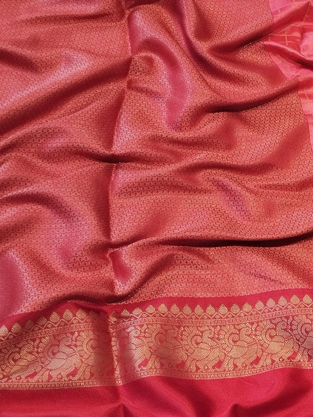 Rich red Banarasi silk saree fabric with gold border detail