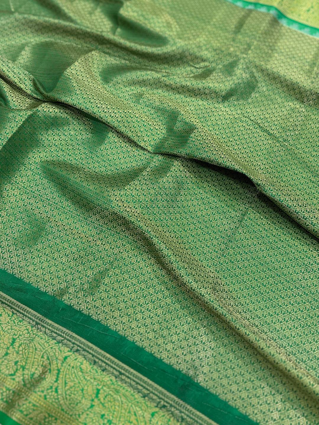 Detailed view of green pattern on Banarasi saree fabric