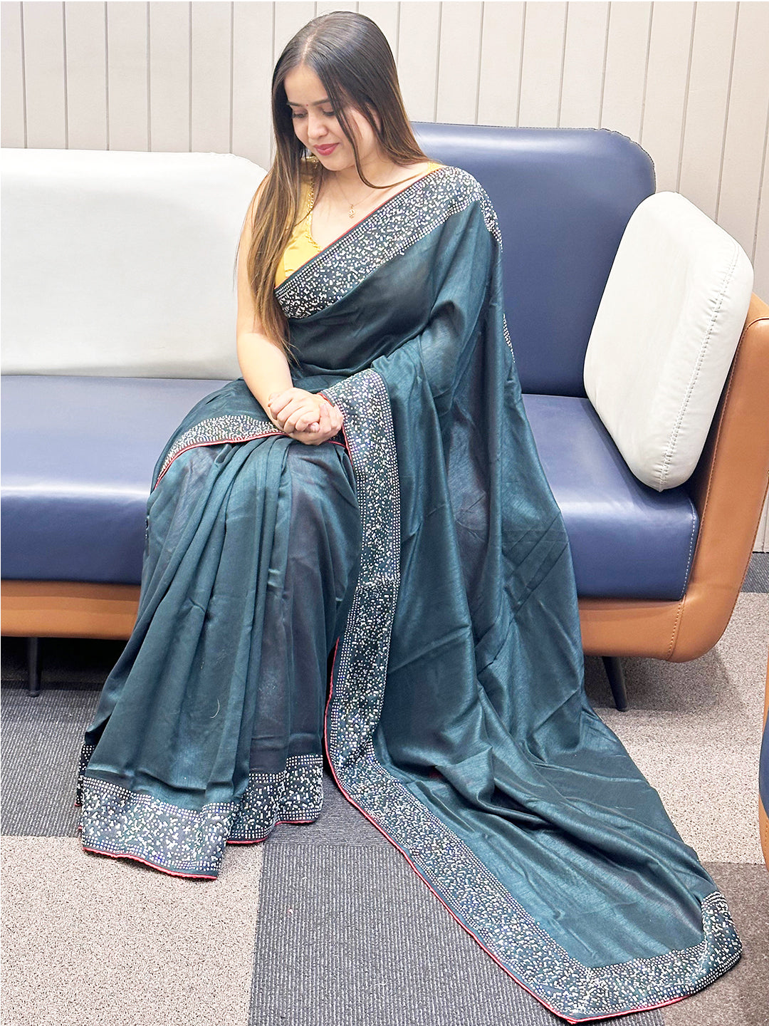 Dark green Vichitra silk saree with Swarovski stones, seated pose