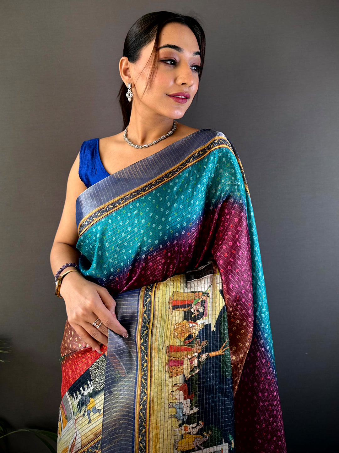 Heritage Silk Blend Bandhani Print Saree featuring vibrant hues and intricate patterns, draped elegantly with a blue blouse for a sophisticated look.