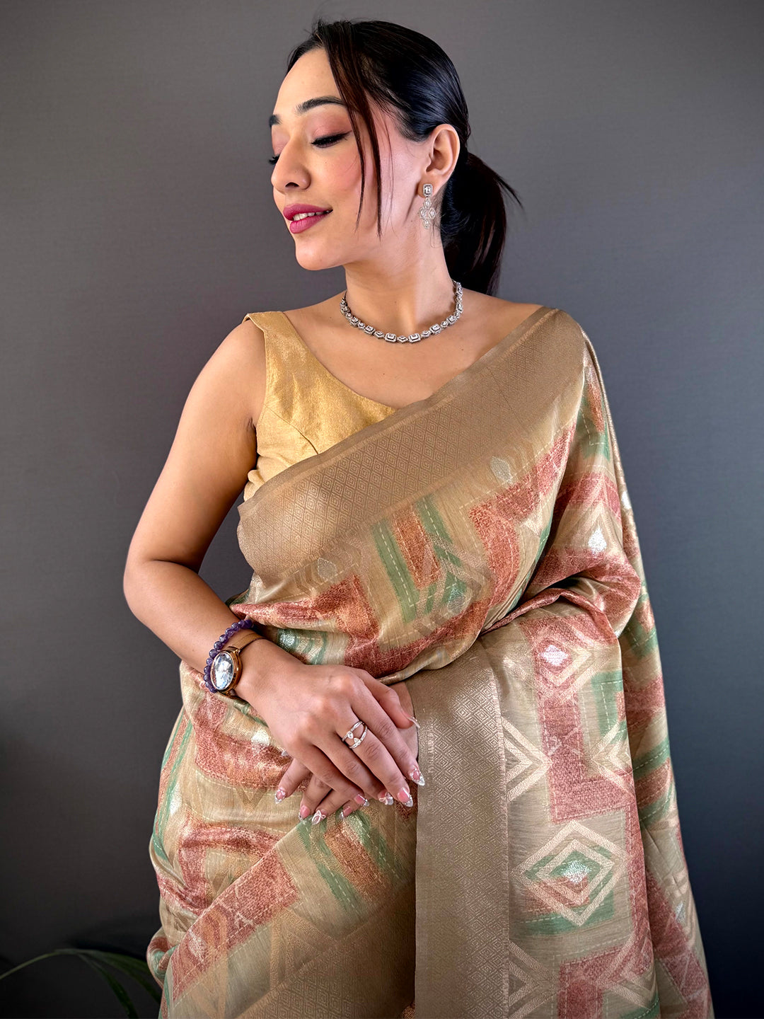 Elegant Beige Banarasi Silk Katan Geometric Saree with intricate patterns, draped gracefully. Perfect for weddings and festive occasions.