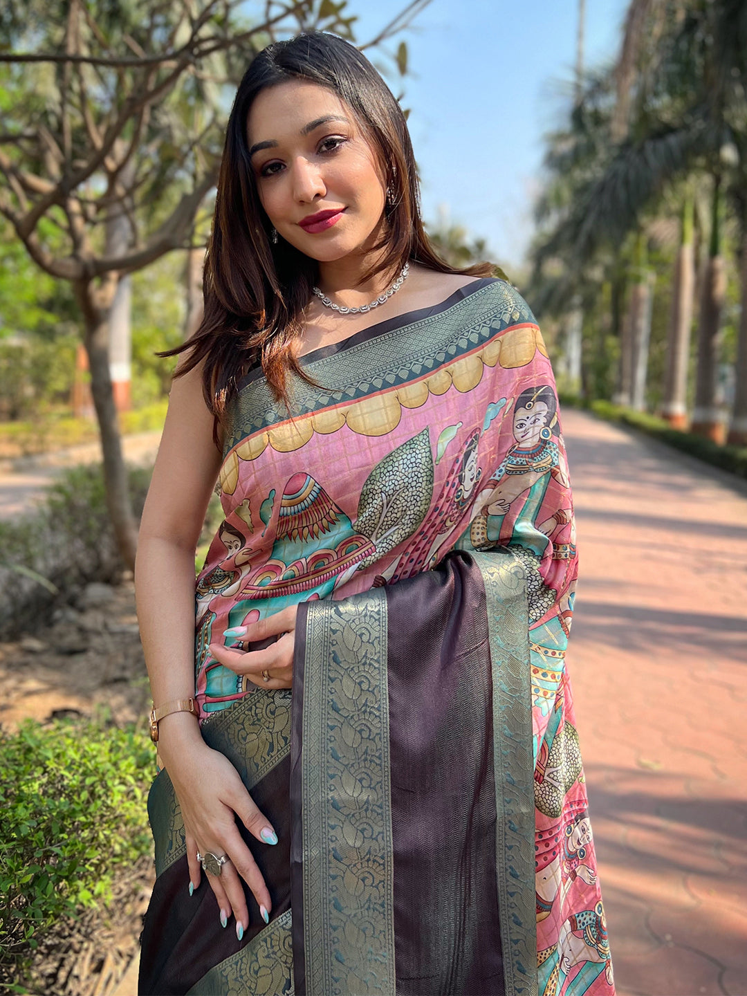 Model wearing pink Banarasi saree with elegant border design