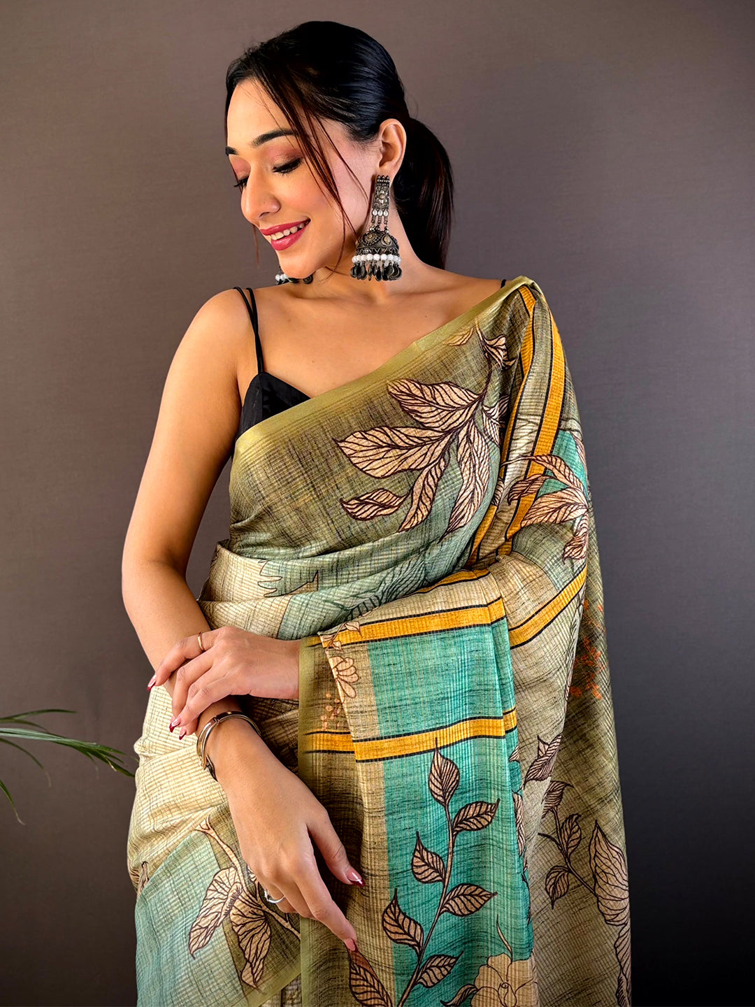 Green abstract floral zari tussar saree with leaf motifs.