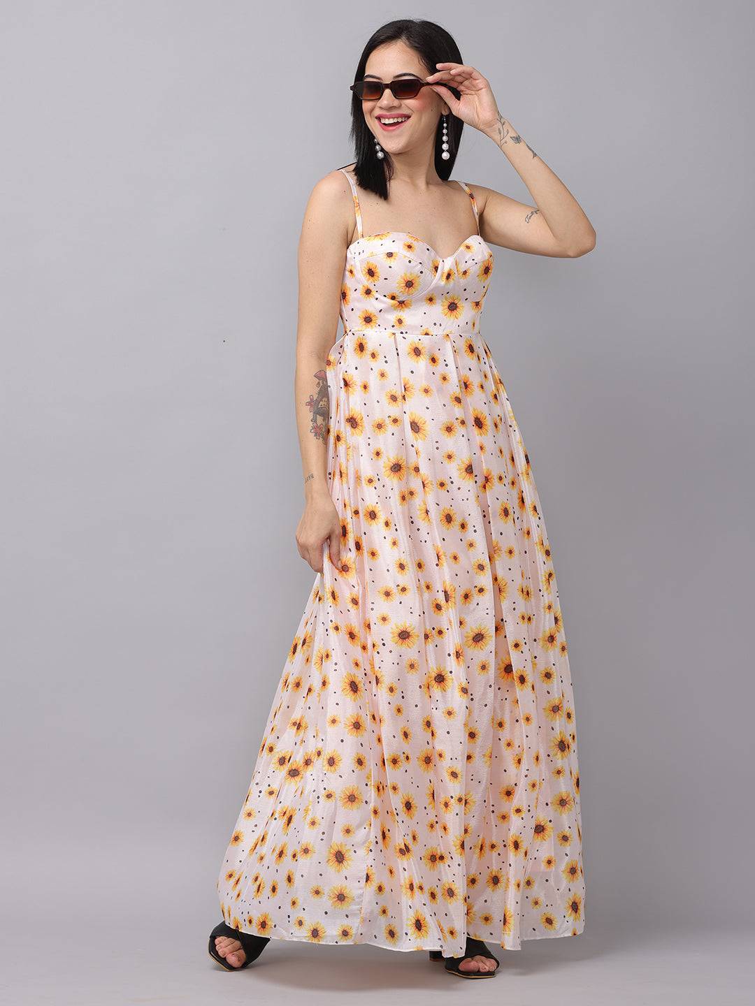 Model posing in white sunflower printed dress, side view.