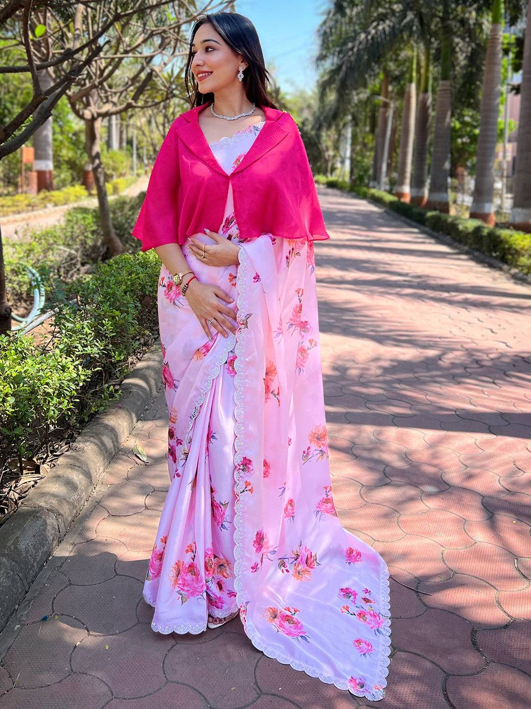 Pink satin georgette saree with floral print and zircon border