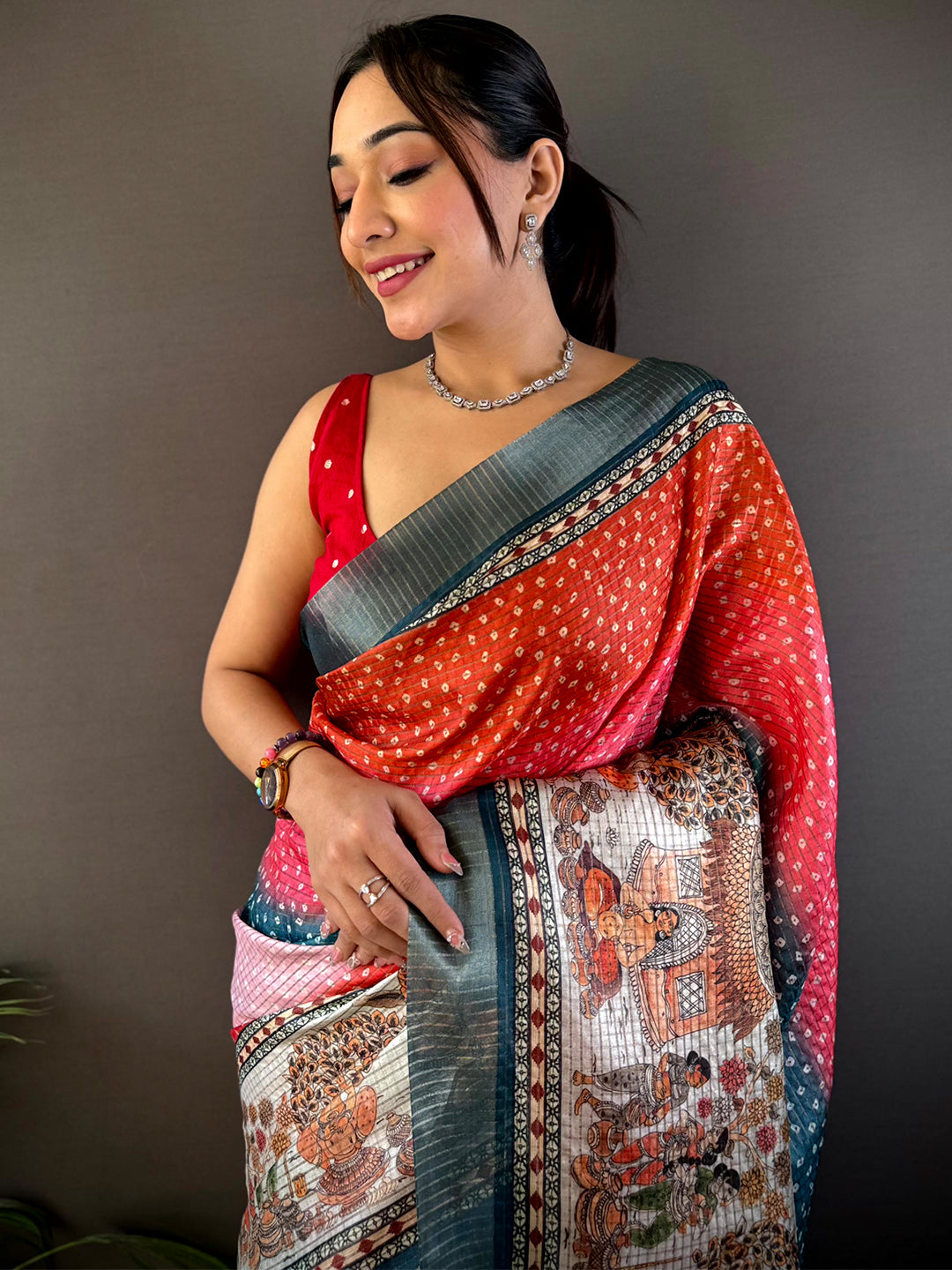 Radiant Silk Blend Bandhani Print Saree with intricate patterns and vibrant hues, draped elegantly. Perfect for festive and wedding occasions.