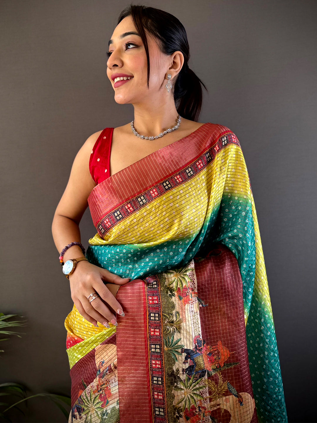 Elegant Silk Blend Bandhani Print Saree in vibrant yellow, green, and maroon hues with intricate patterns, draped gracefully for a festive look.