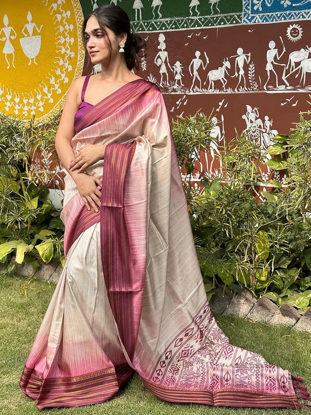 Wine Ikkat Ghicha saree with paisley prints worn by a woman