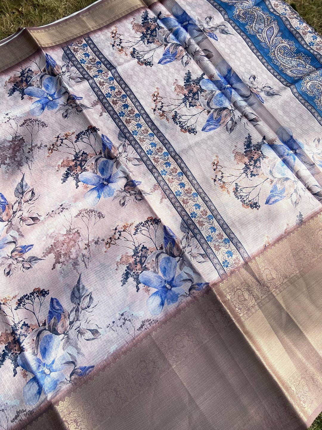 Full view of light pink saree with blue floral print and gold border