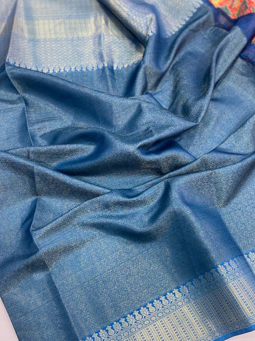 Detailed view of blue Moonga silk fabric with intricate patterns