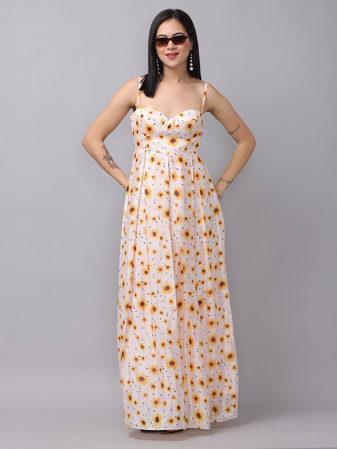 White sunflower printed dress with sweetheart neckline, hands in pockets.