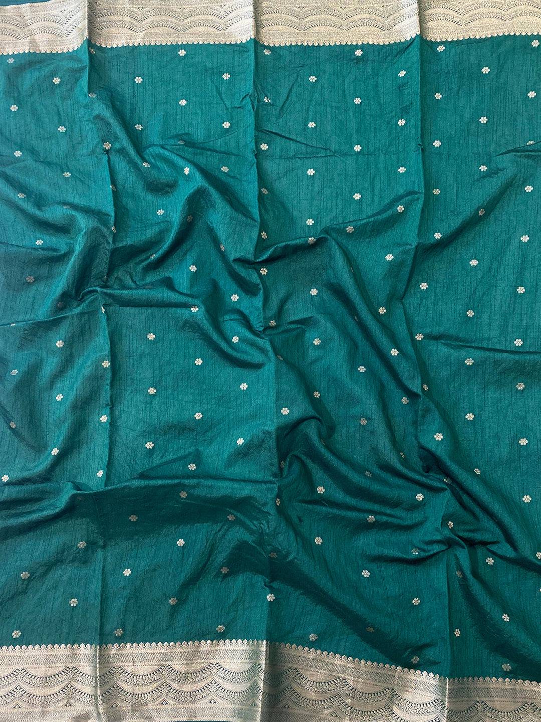 Green blouse fabric with intricate gold zari embroidery.