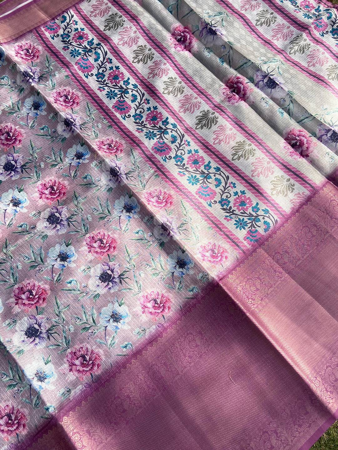 Detailed view of floral print and gold zari border on saree