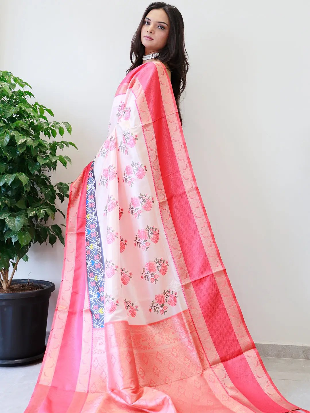 Elegant soft silk saree featuring red Gadwal border and floral design