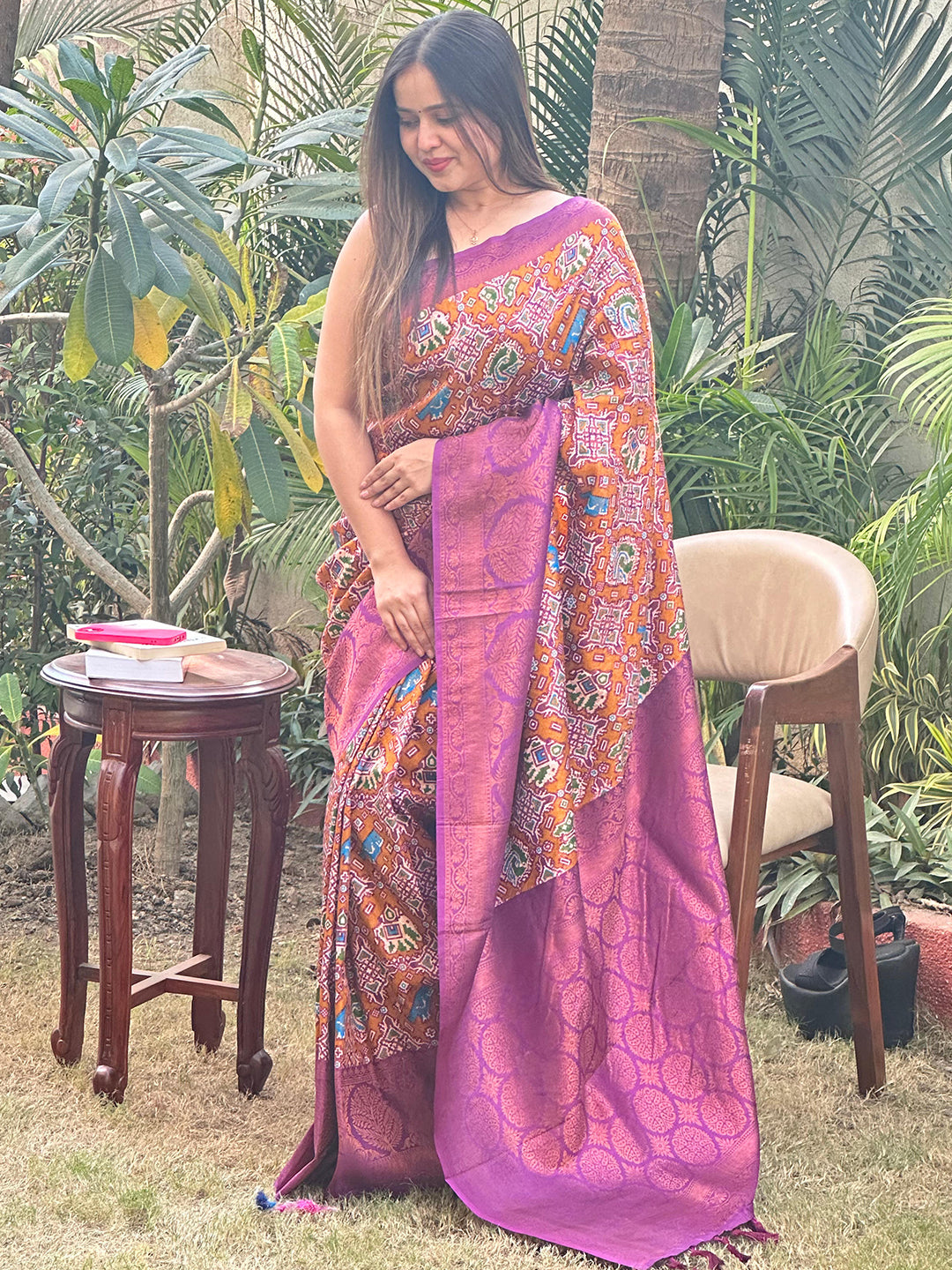 Elegant purple Patola saree with colorful motifs