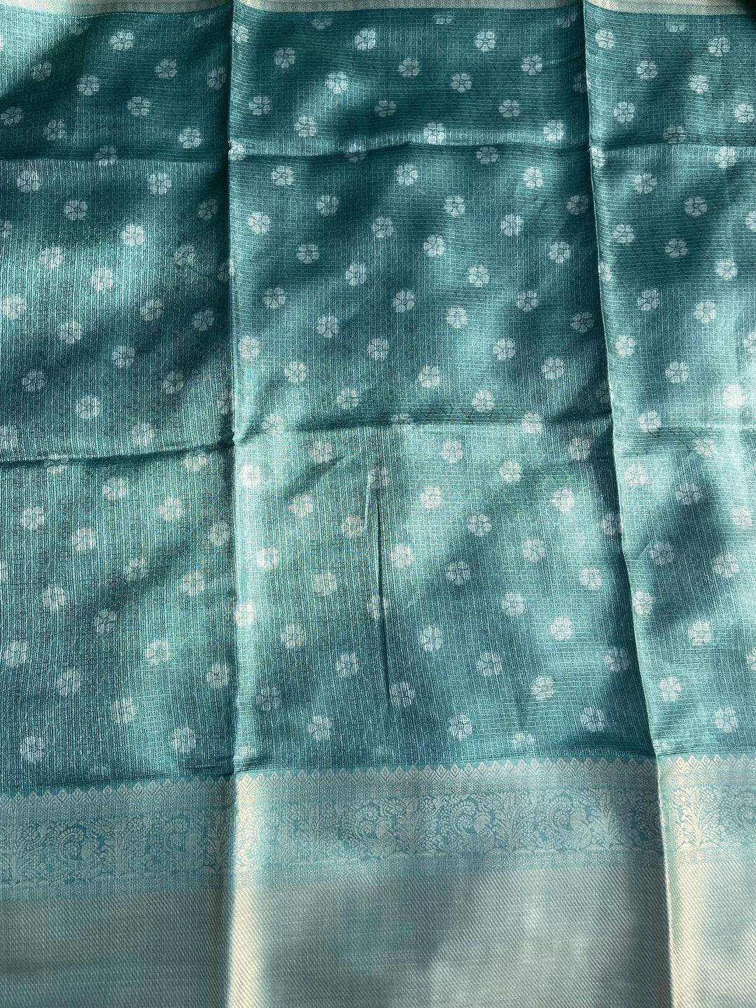 Teal patterned fabric with gold zari border on saree