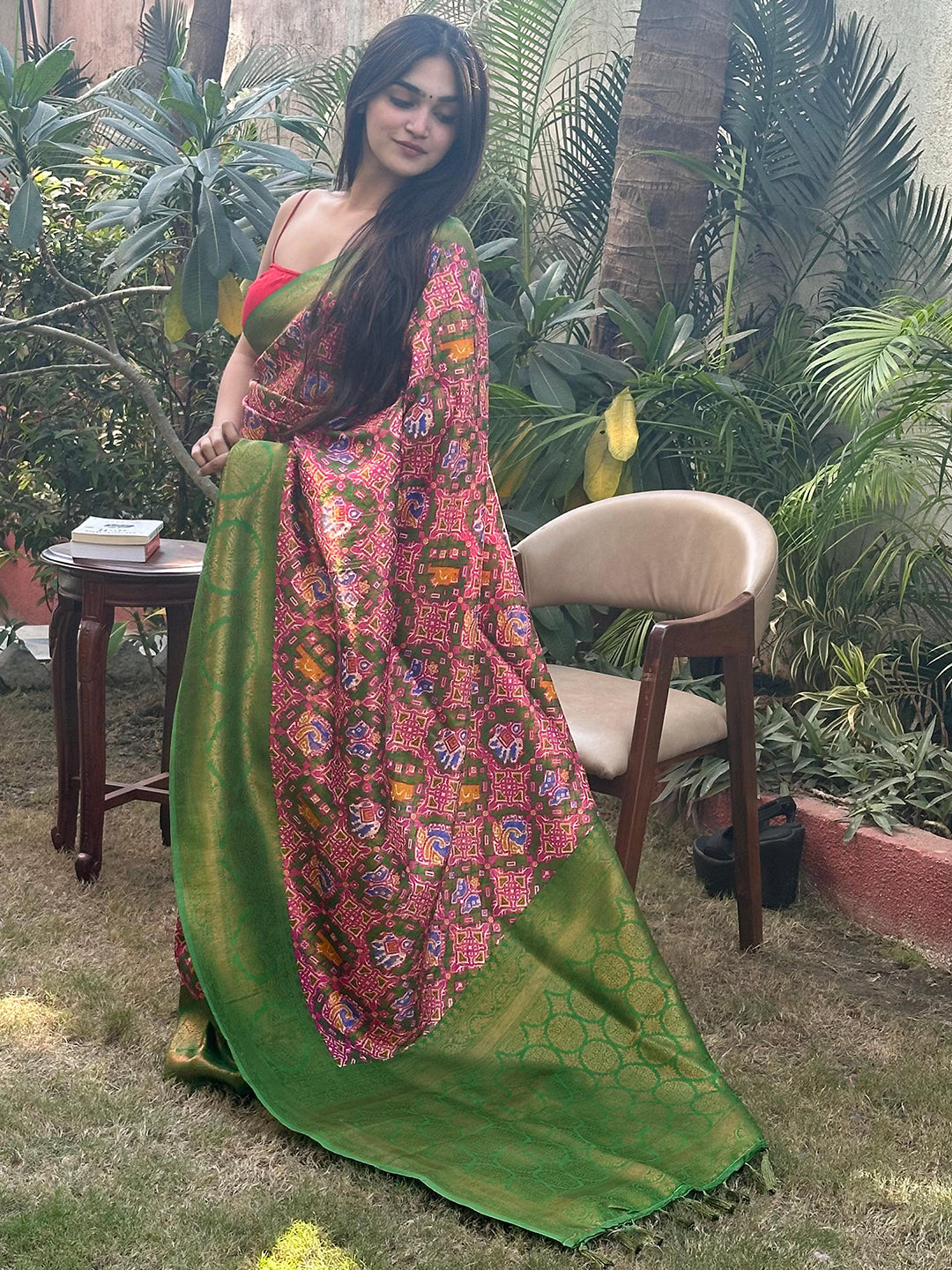 Patola saree with vibrant green and gold zari design