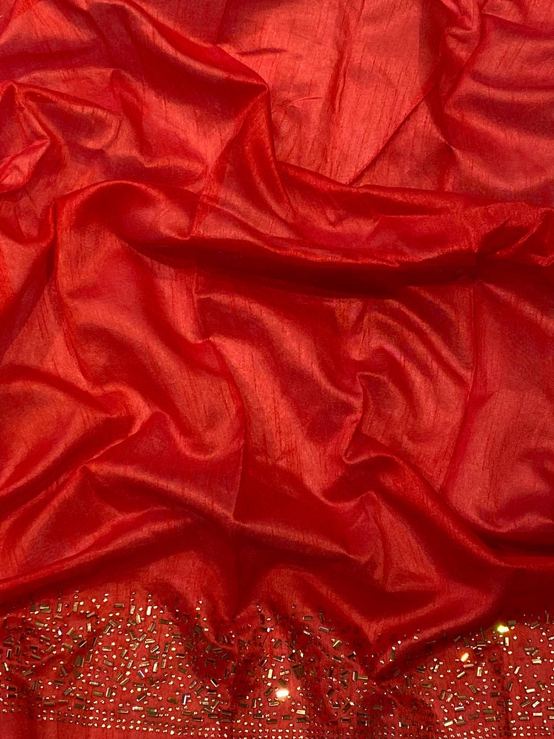 Close-up of Red Silk Fabric with Swarovski Embellishments