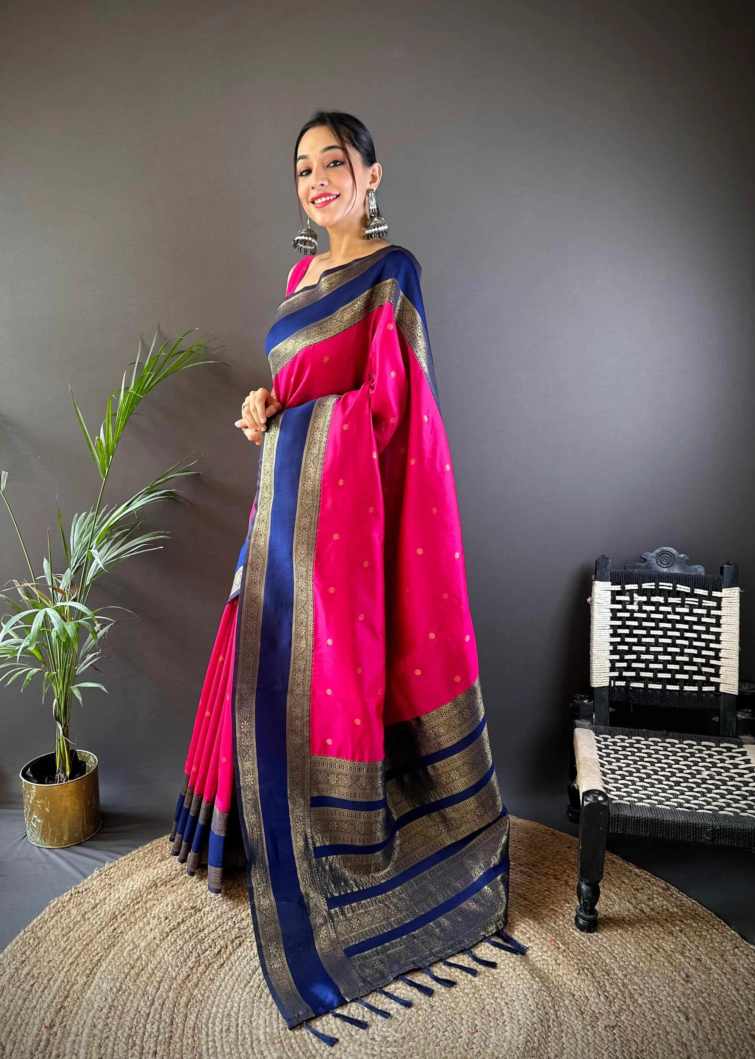 Stylish pink Banarasi saree featuring blue and gold borders