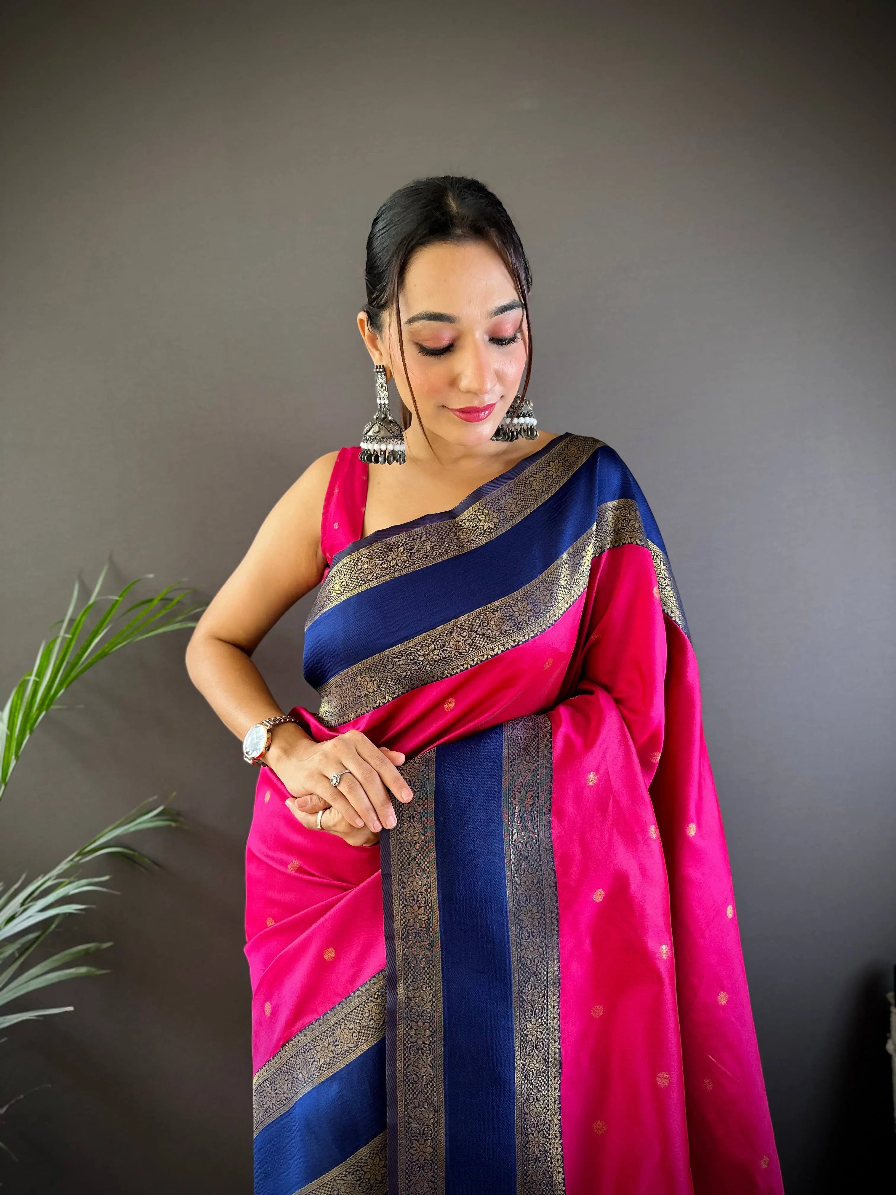 Close-up of pink Banarasi saree with intricate blue and gold design