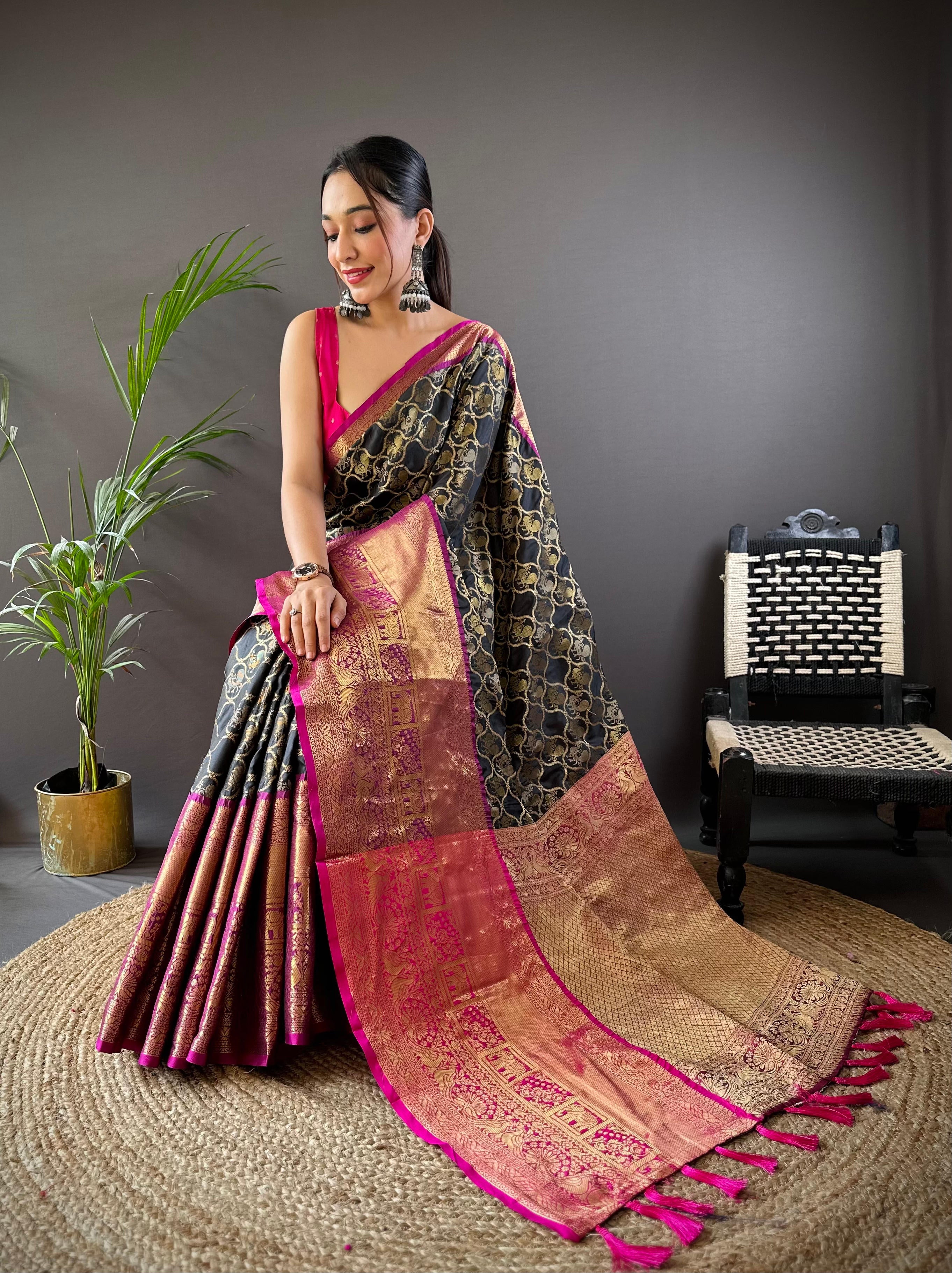 Model wearing Black Banarasi Zari Butti Saree seated