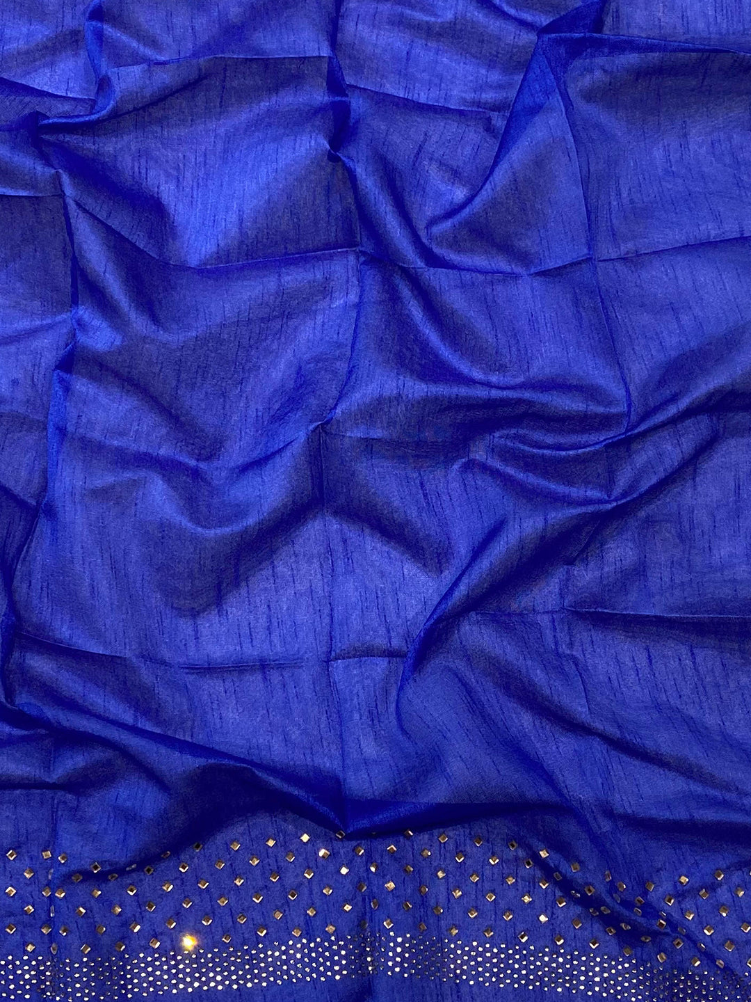 Close-up of blue fabric with Swarovski stone embellishments