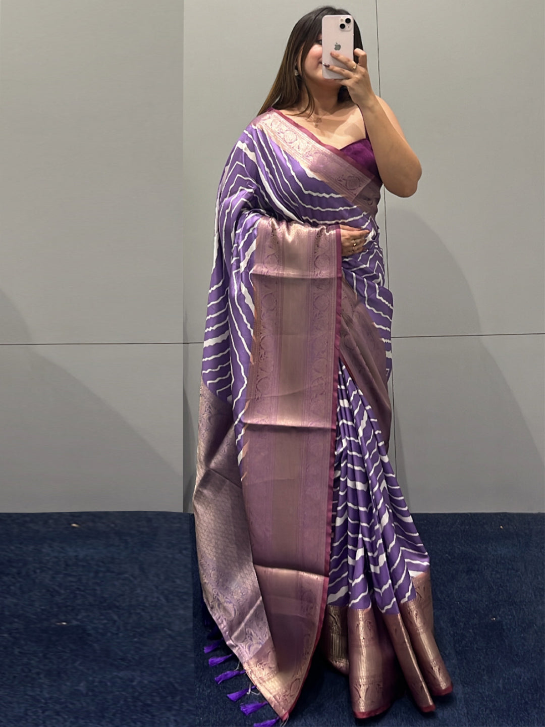 Elegant purple leheriya saree with intricate zari border.