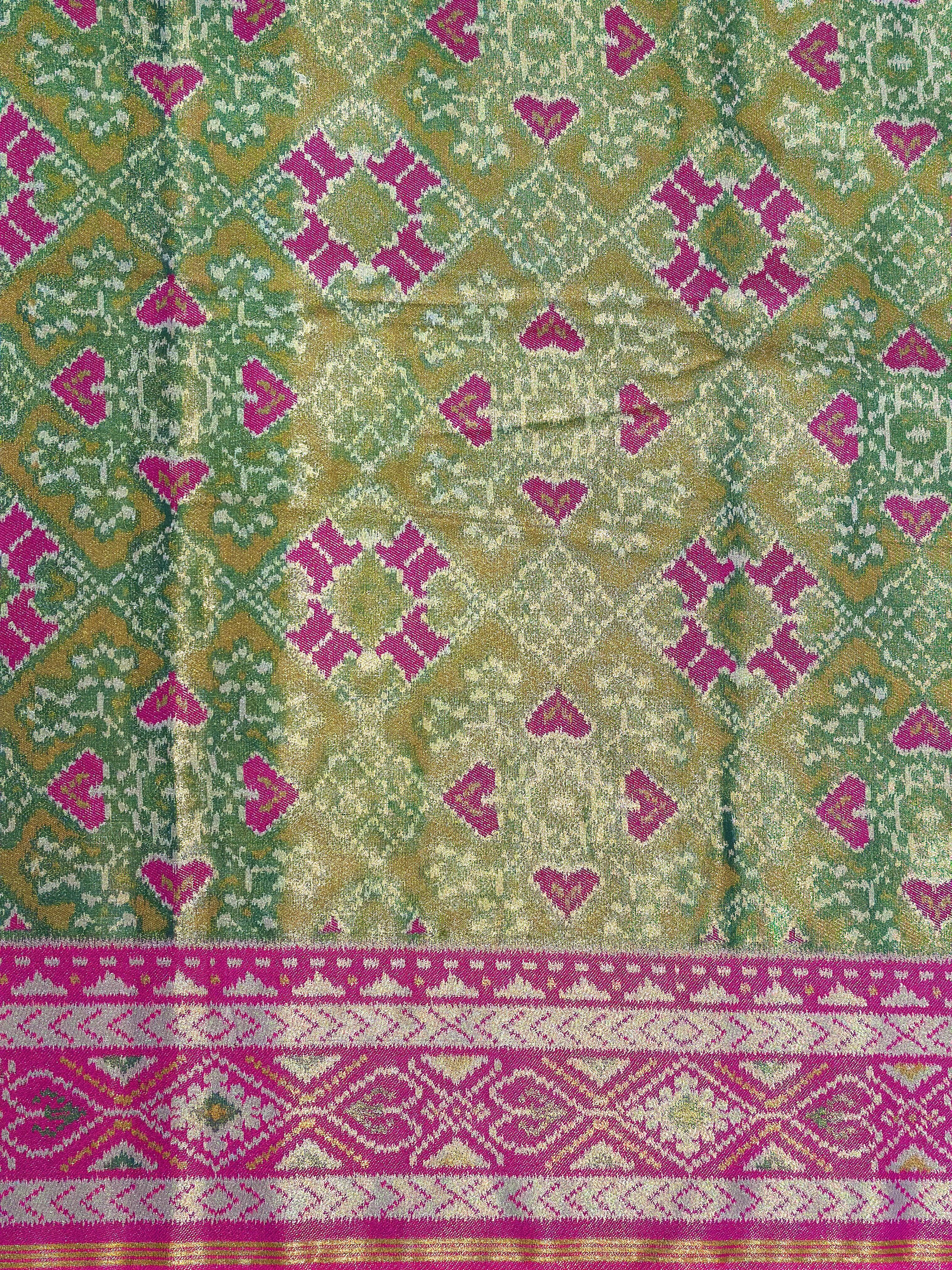 Patterned section of Mendi Green Double Ikkat Semi Silk Patola