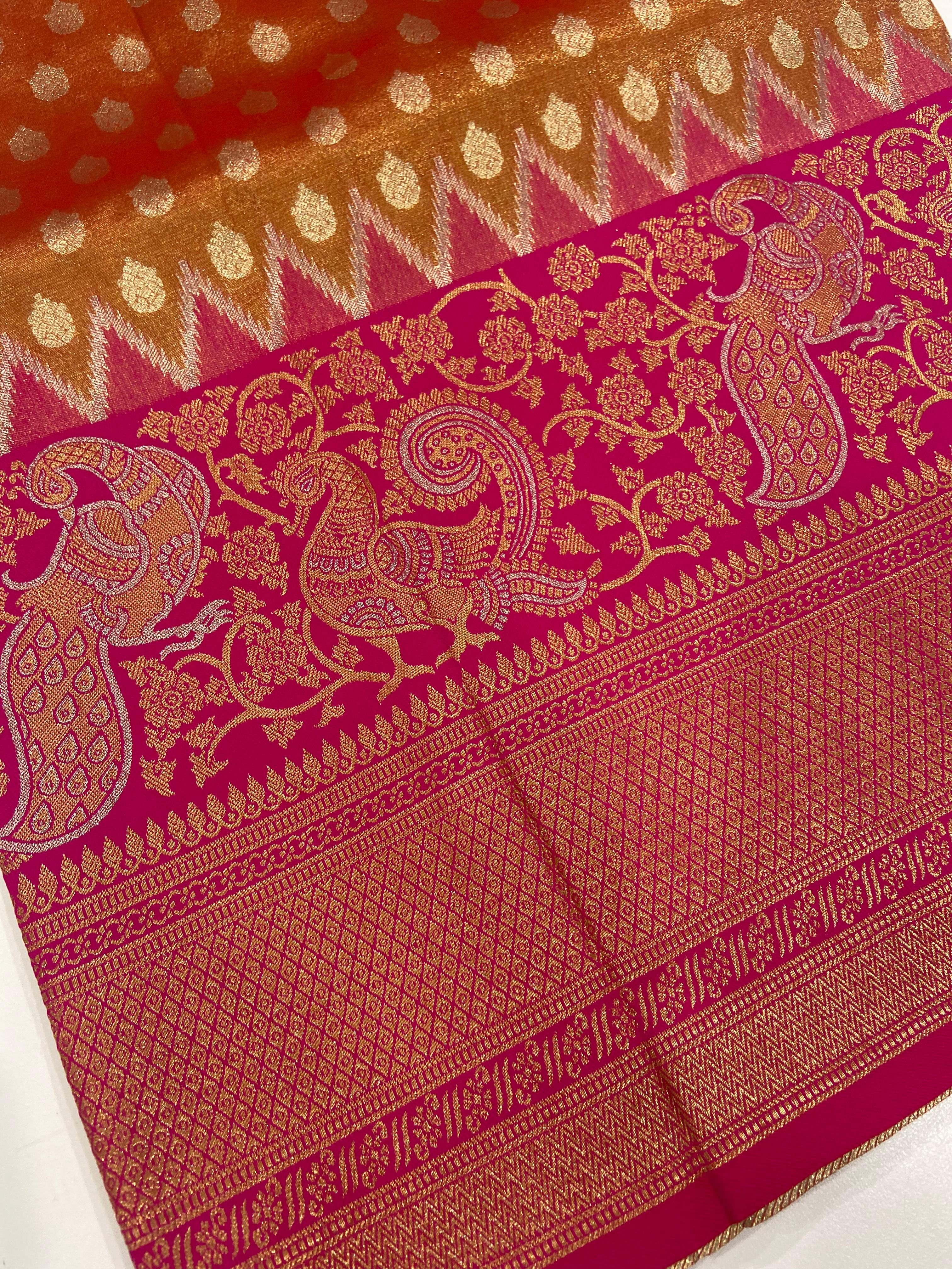 Close-up of intricate floral and paisley motifs on saree